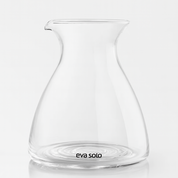 Clear glass carafe with 'eva solo' branding on a white background